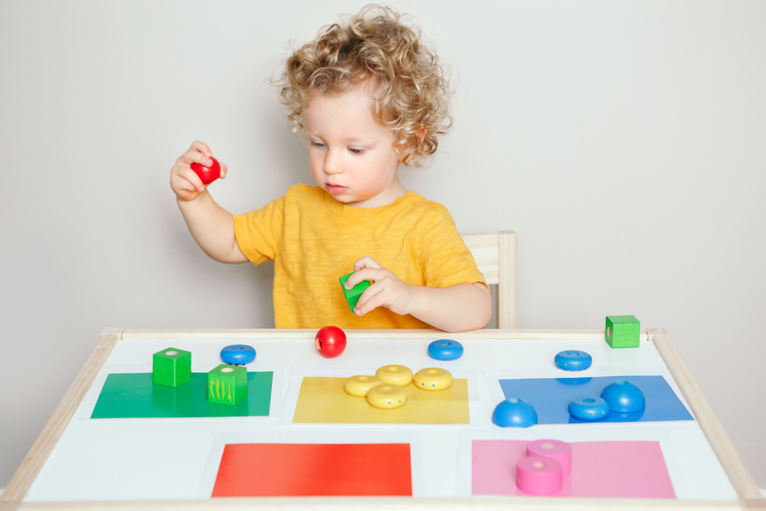 Toddler Playing with Learning Toys